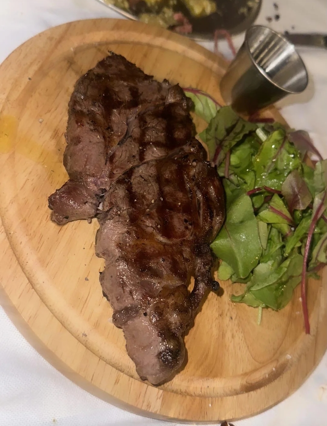 Grilled sirloin steak with fresh greens