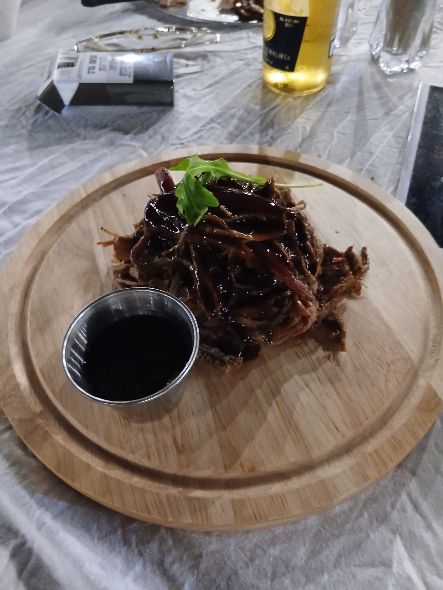 Pulled brisket in BBQ sauce on a board